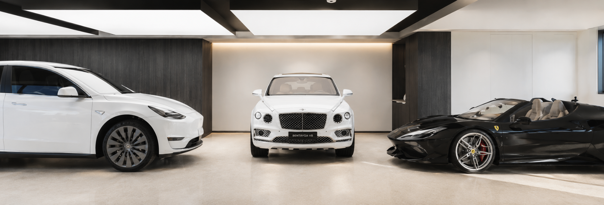 Minimalist garage with luxury cars and integrated ceiling lighting