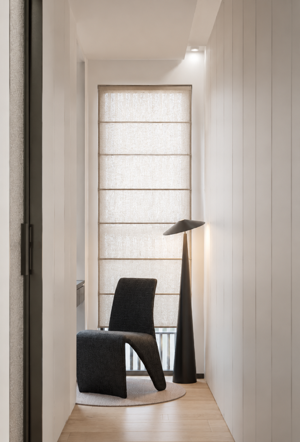 Minimalist corridor reading nook with sculptural chair